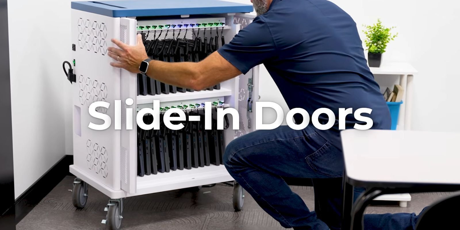 Person demonstrating the slide-in doors on a JAR Systems USB-C charging cart designed for secure Chromebook storage and charging.