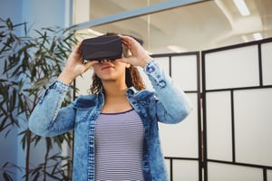 Low angle view of young female executive enjoying virtual reality headset at creative office.jpeg