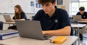 Student using a power bank at his desk